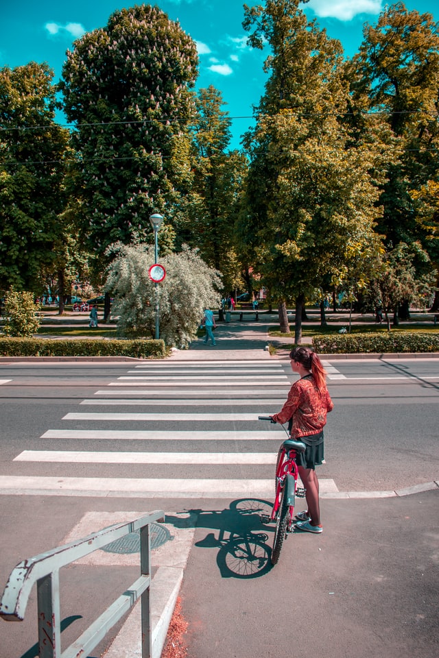 girl with bike at crosswalk